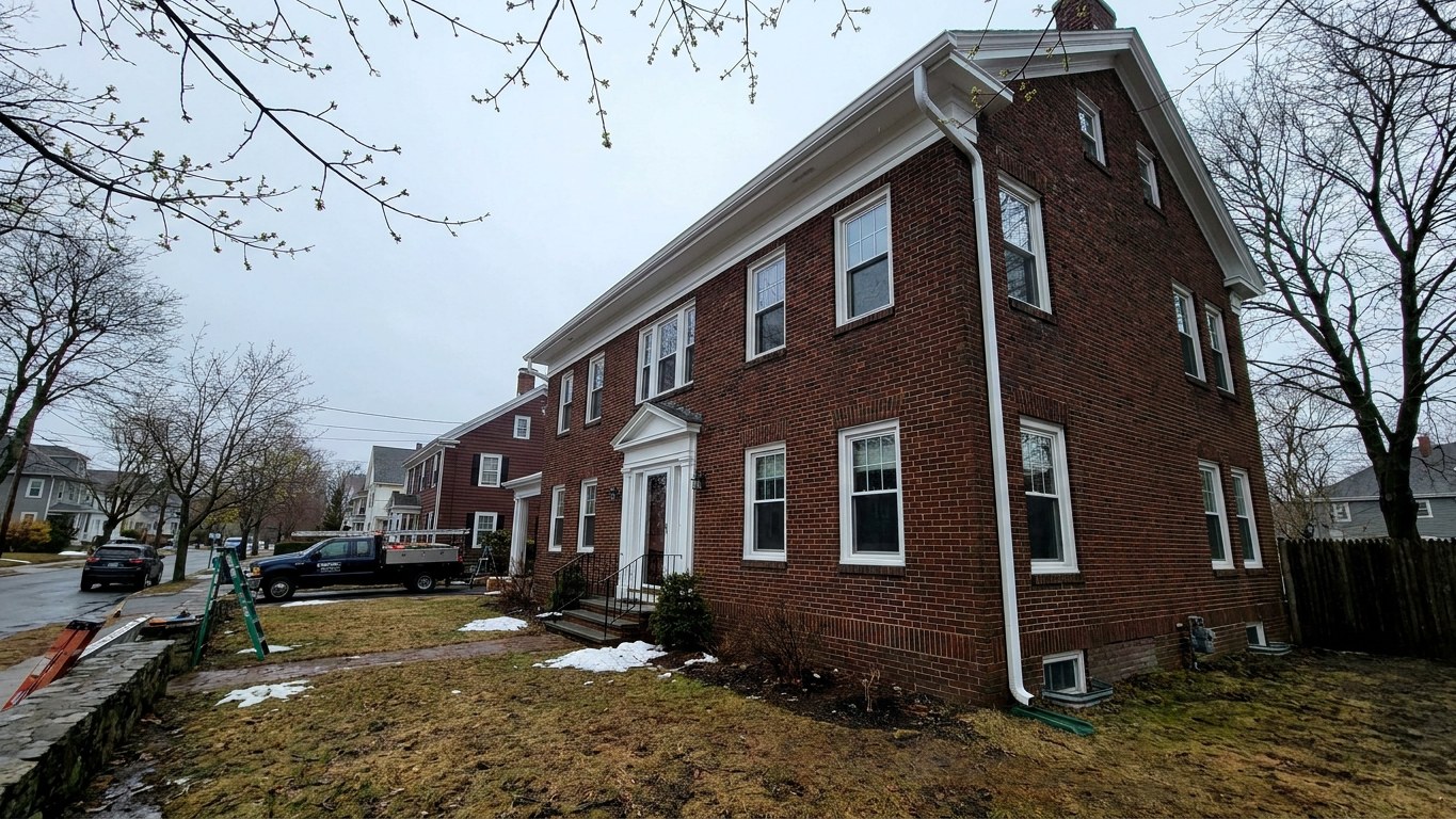 New seamless aluminum gutter installation on a colonial home in Lawrence Massachusetts Essex County Merrimack Valley ice dam ice-load spec